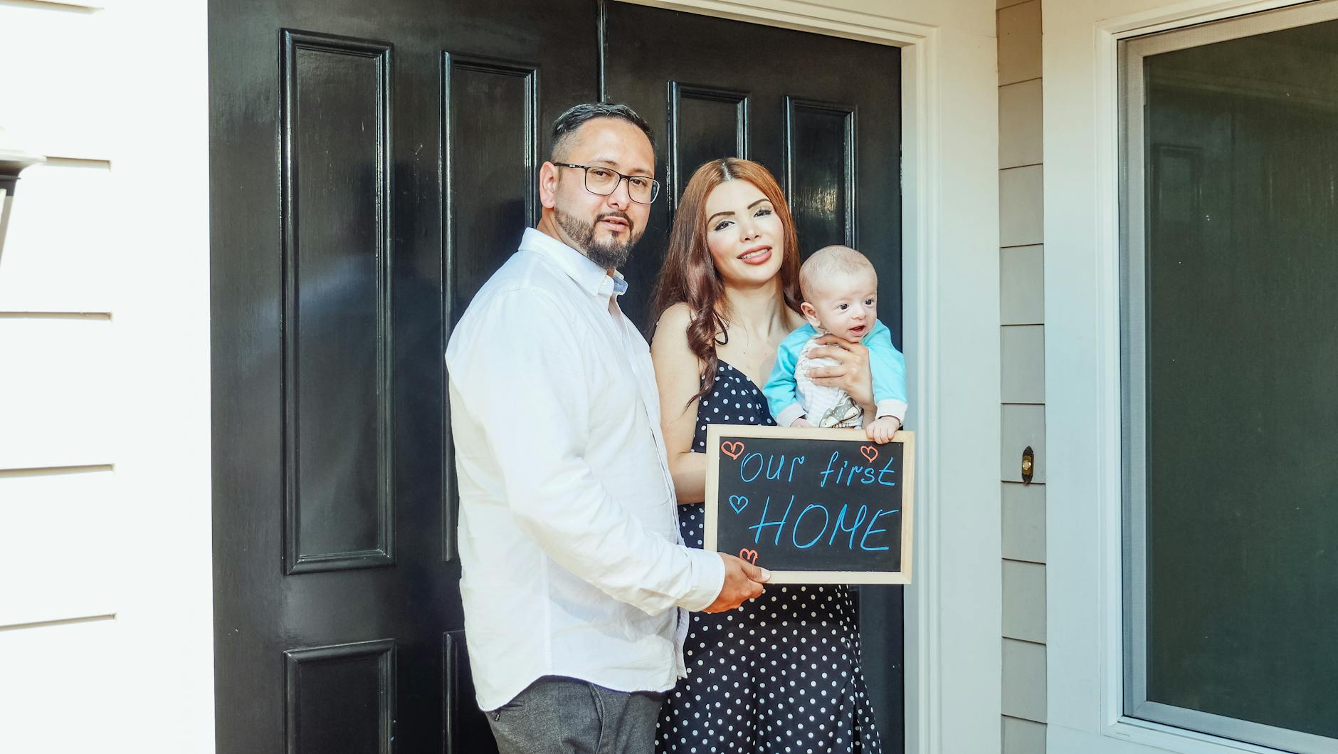 family standing by their front door